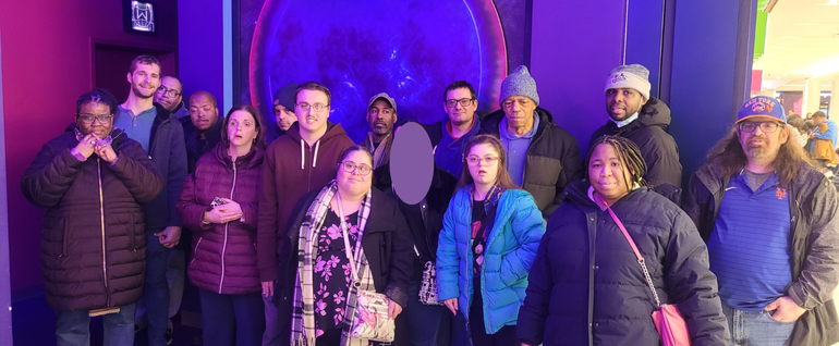 A large group of adults standing outside of the mirror maze activity at American Dream Mall.