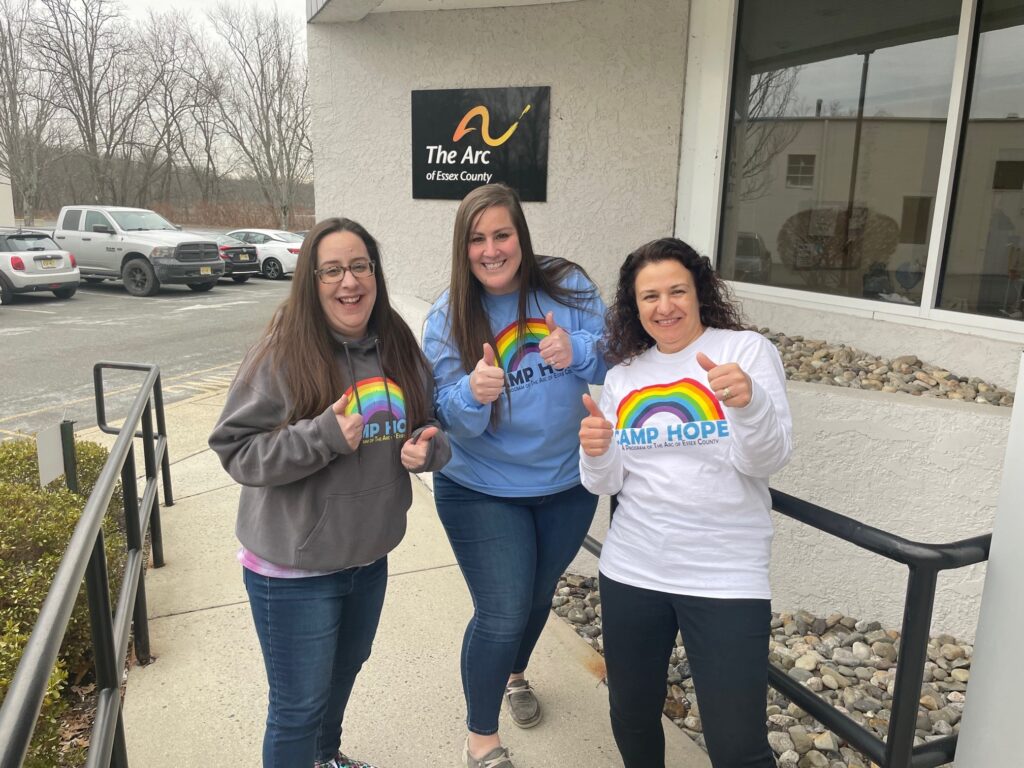 Angela, Stacey, and Sara from the Camp Hope team, wearing Camp Hope gear