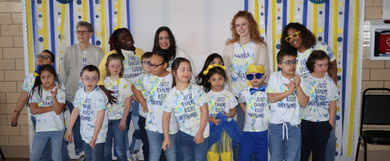 A group of students wearing shirts that say 