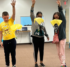 Teenagers tossing yellow parachutes