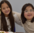 Two children sit at a Thanksgiving themed table together.