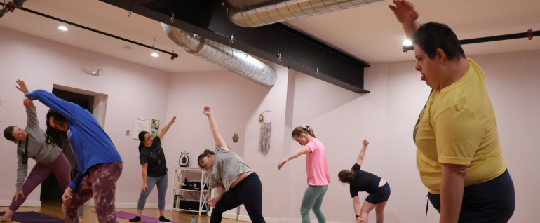 A group of adults participating in a yoga class.