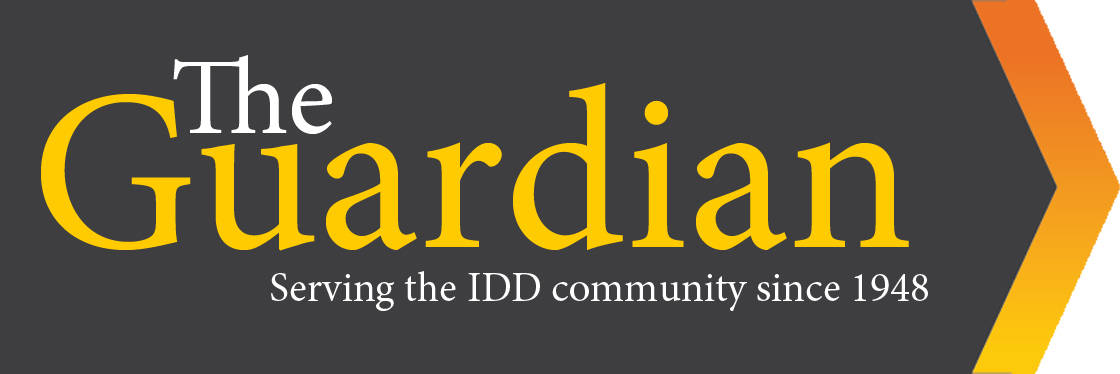 "The Guardian: Serving the IDD community since 1948" written on a black background. On the right side, an orange and yellow chevron pointing to the right.