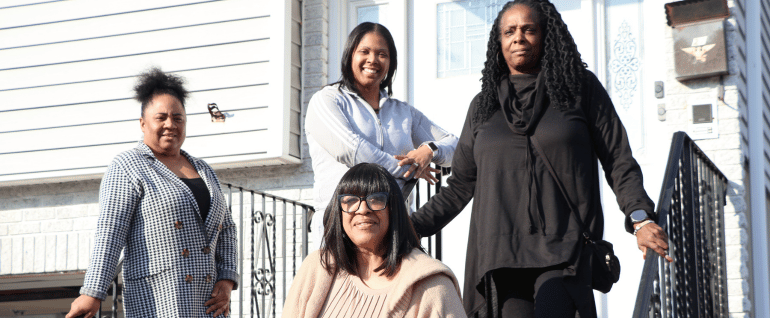 Four women stand in front of Claremont Group Home