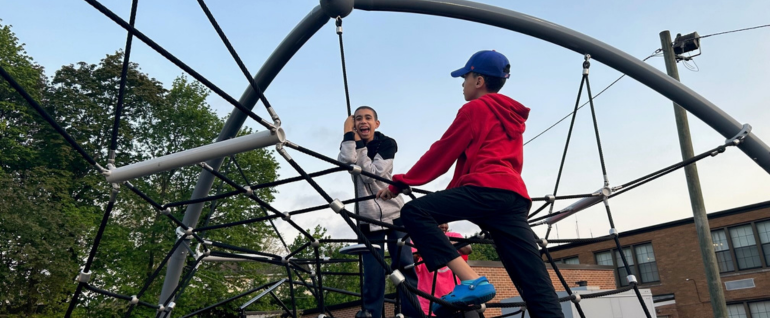 Children climbing on playground equipment.