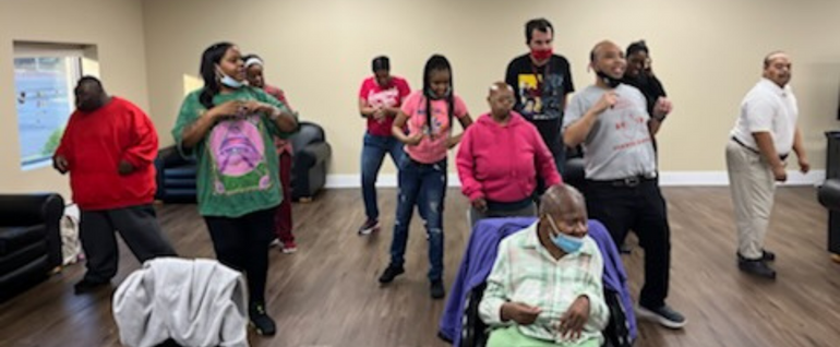 A group of people dancing in a large open room.