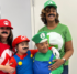 A mother and son dressed as Mario and a mother and son dressed as Luigi