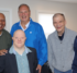 Four residents of the 45 Beechtree group home stand with West Caldwell Mayor Joe Tempesta (center, in a bright blue jacket) in the livingroom of their new home.