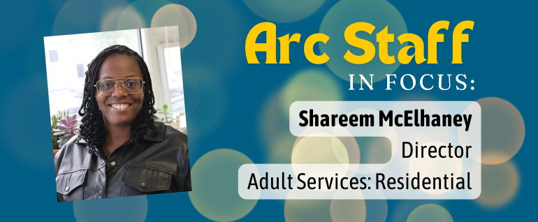 Blue background with the text "Arc Staff In Focus: Shareem McElhaney, Director Adult Services Residential" and a photo of a smiling woman with glasses and a black jacket.