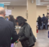 Tables in a large room with information displays and people in discussion at the tables.